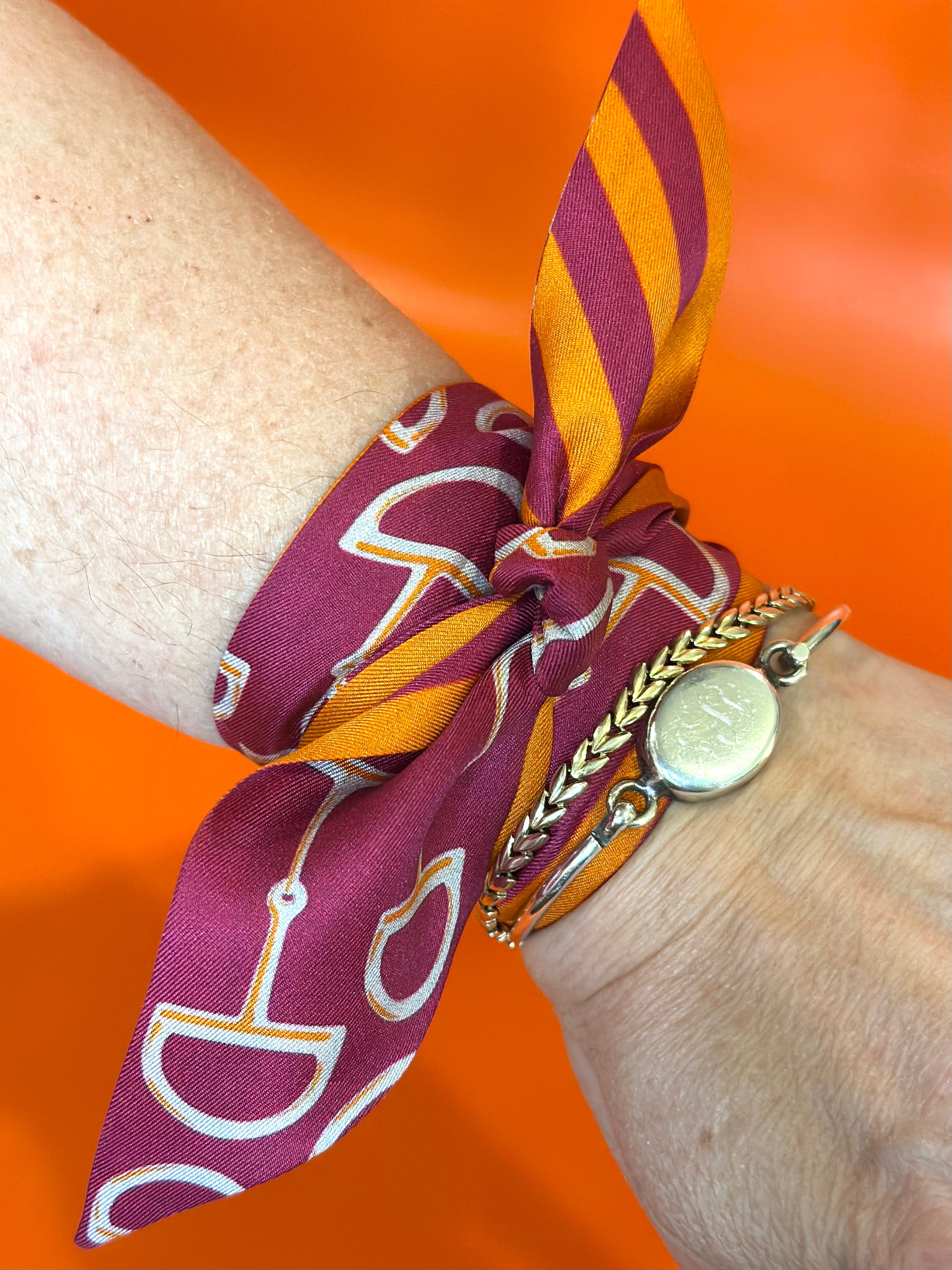 Gameday Luxe Signature Orange and Maroon Gameday Scarf as bracelet