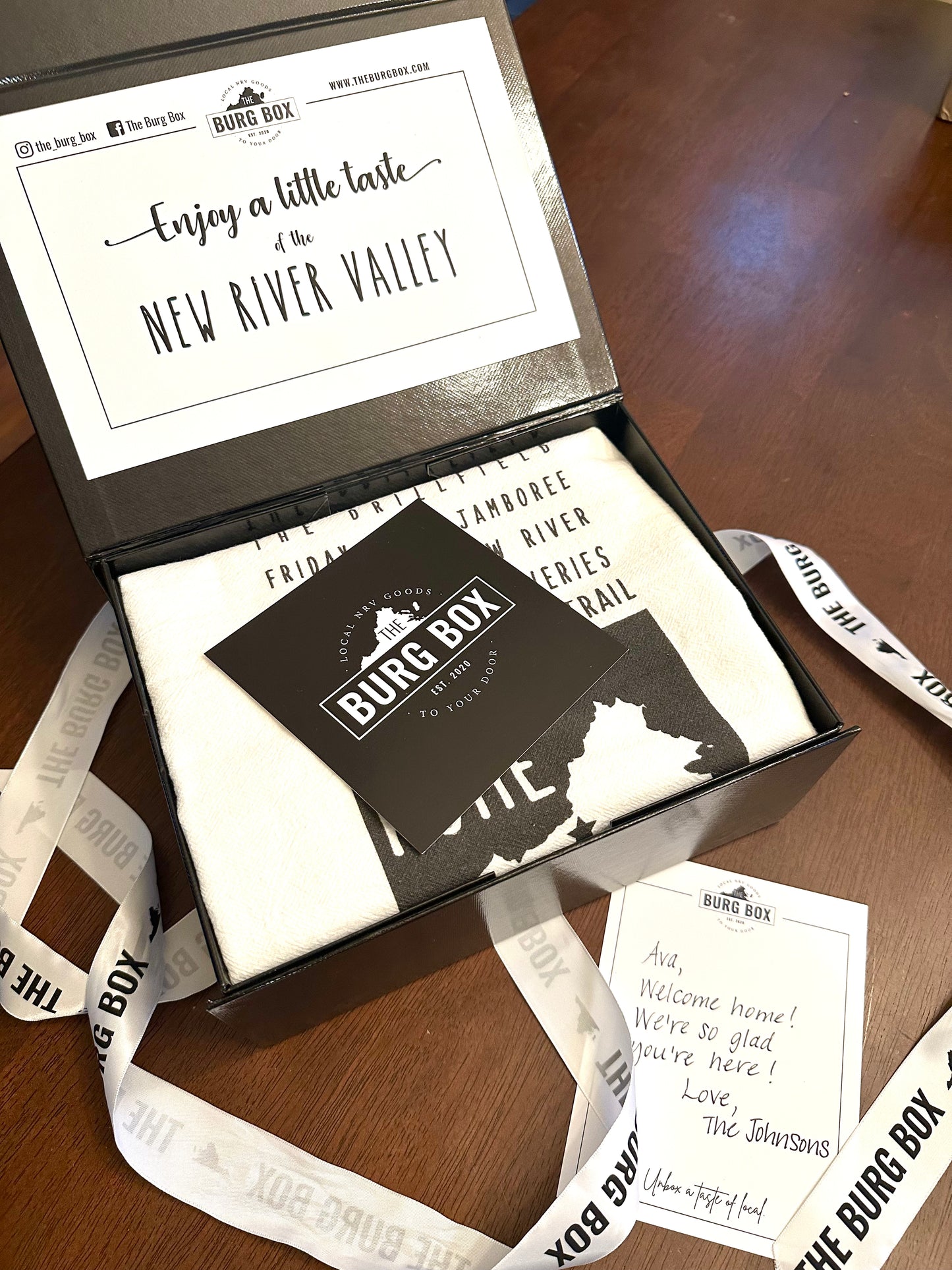 Photo of The Hometown Box open with ribbon laying around it