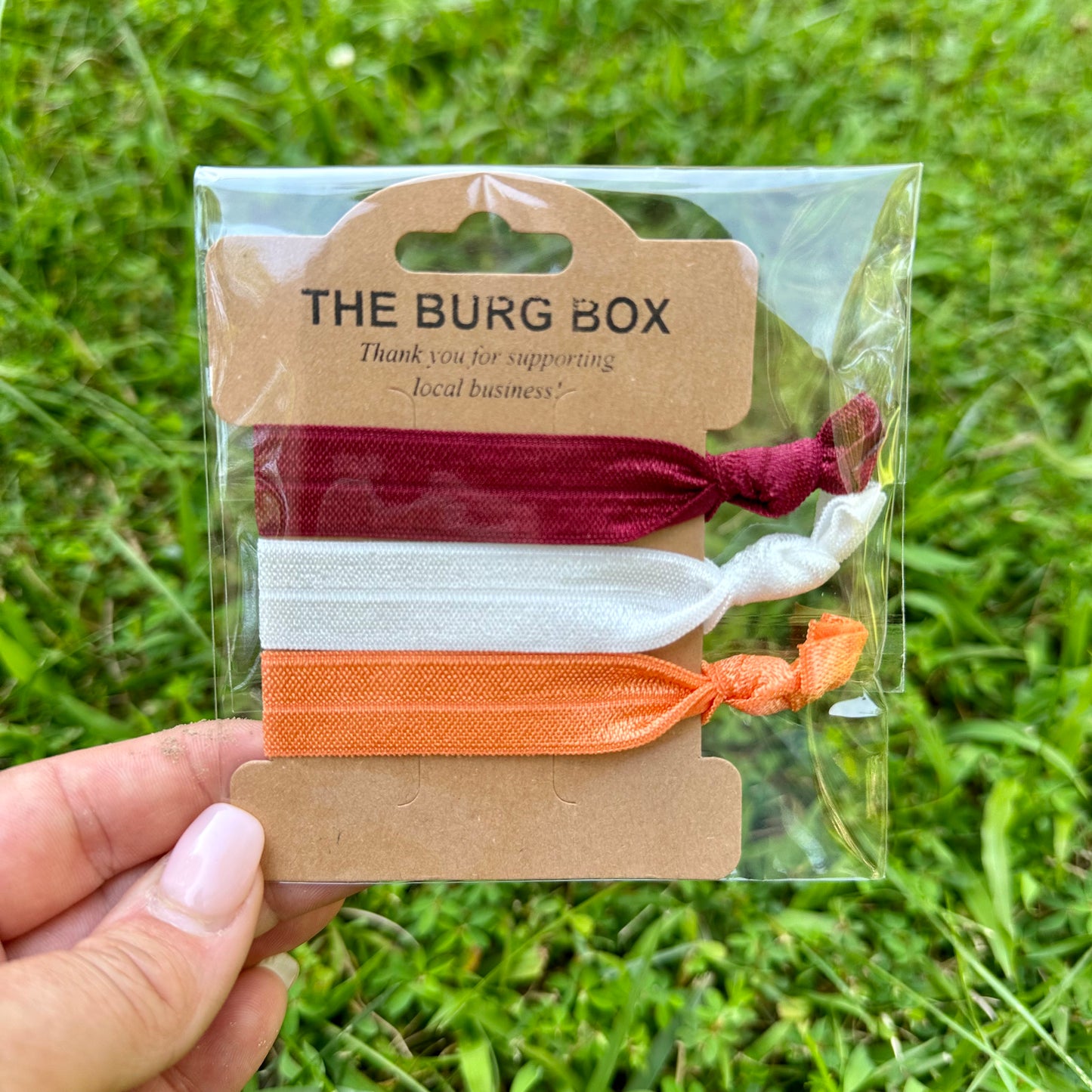 Maroon white and orange elastic hair ties